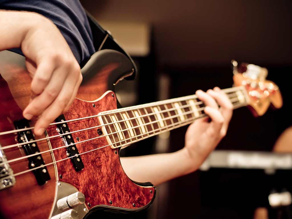 Student learning to play bass