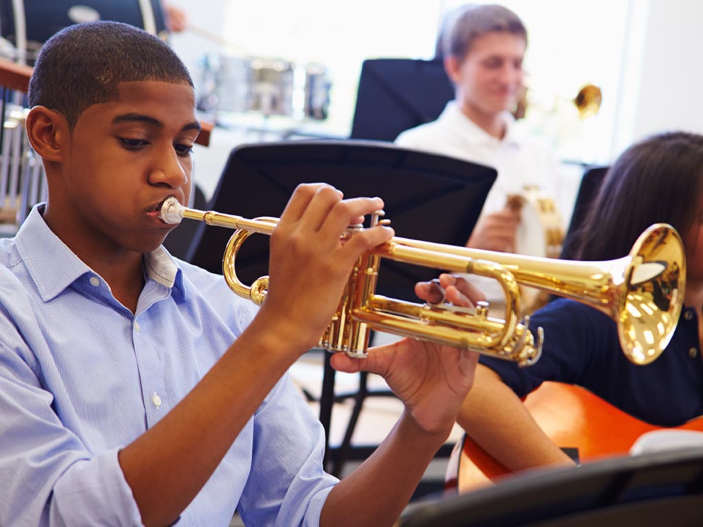 Student learning to play trumpet
